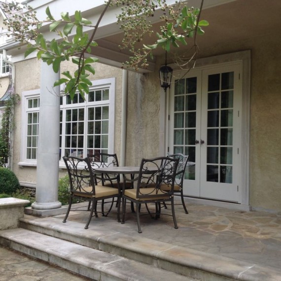 photo of rear porch with table and door